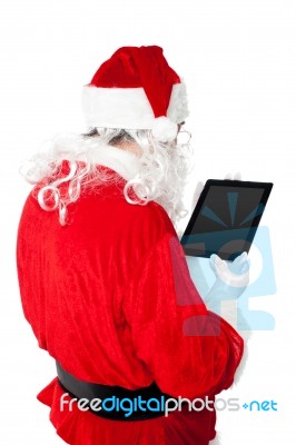 Santa Busy In Operating Tablet Pc Stock Photo