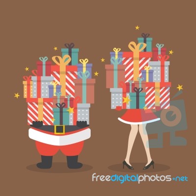 Santa Claus And Santa Woman Holding A Pile Of Gift Boxes Stock Image