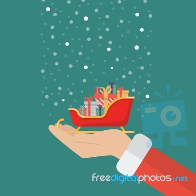 Santa Claus Hand Holding Sleigh Containing A Full Of Presents Stock Image