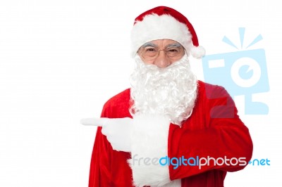 Santa Claus Pointing Away Over White Stock Photo