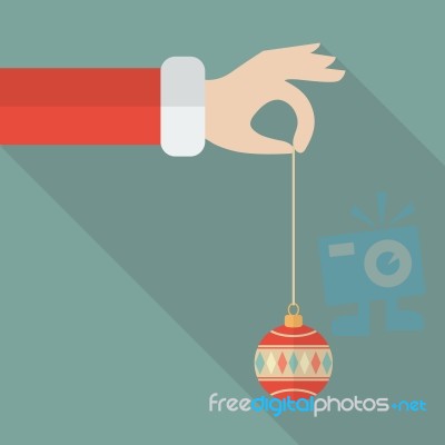 Santa Hand Holding Christmas Ball Stock Image