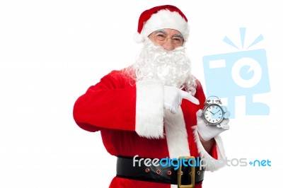 Santa Pointing At An Antique Time Piece Stock Photo