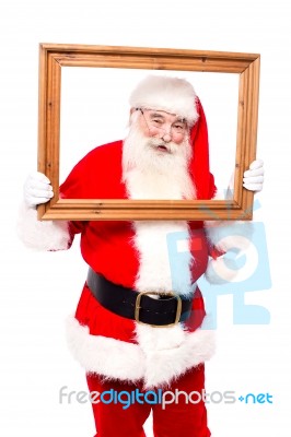 Santa Posing Holding Wooden Frame Stock Photo