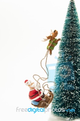 Santa Riding On Sleigh Along Christmas Tree Stock Photo