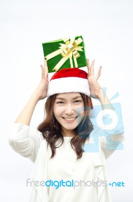 Santa Woman Showing Gift Wearing Santa Hat Stock Photo