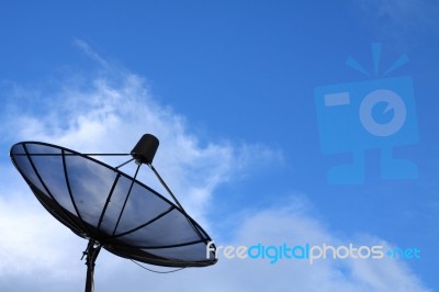 Satellite Dish Against Blue Sky Stock Photo