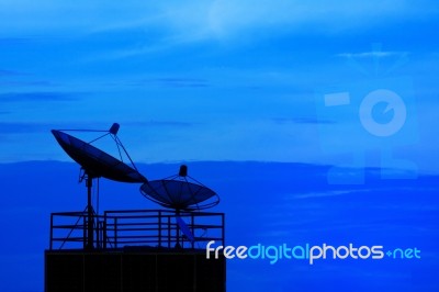 Satellite Dish And Blue Sky On Dusky Time Background Stock Photo