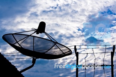 Satellite Dish And Electricity Post In Morning Sky Stock Photo