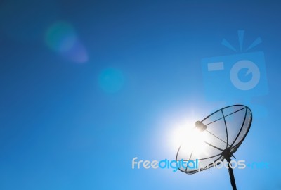 Satellite Dish And Shining Sun Stock Photo