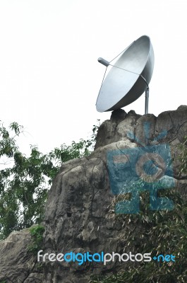 Satellite Dish On Rock Stock Photo