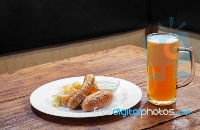 Sausages With Vegetables And Mug With Beer Stock Photo