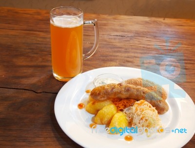 Sausages With Vegetables And Mug With Beer Stock Photo