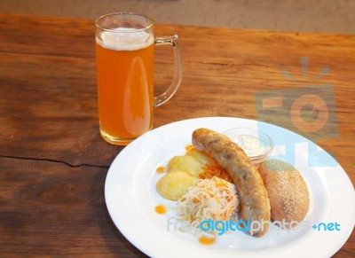 Sausages With Vegetables And Mug With Beer Stock Photo