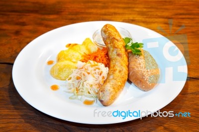 Sausages With Vegetables On A Plate Stock Photo