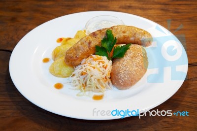 Sausages With Vegetables On A Plate Stock Photo