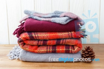 Scarft Gloves And Blanket Stack Stock Photo