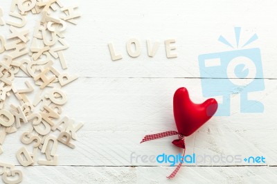 Scattered Wooden Letters And A Red Heart Stock Photo