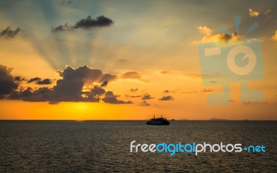 Scenery Of The Sea During Sunset With Ferry Stock Photo