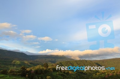 Scenic Of Clouds Over Mountain Stock Photo