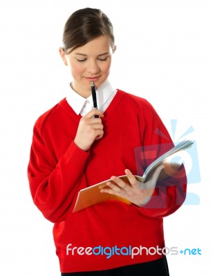 School Girl Looking At Notebook Stock Photo