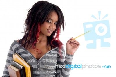 School Girl Posing With Pencil And Books Stock Photo