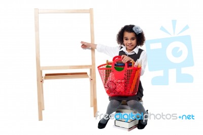 School Girl Sitting On Pile Of Books Stock Photo