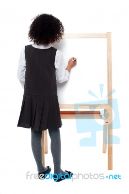 School Girl Writing On White Board Stock Photo