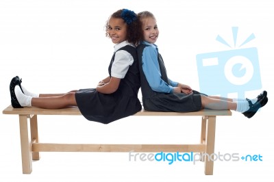 School Girls Leaning Against Each Other Stock Photo