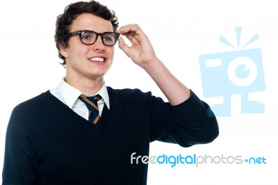 Schoolboy Adjusting His Eyeglasses Stock Photo