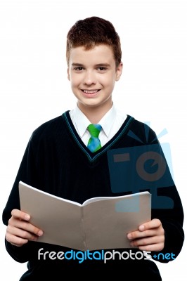 Schoolboy Holding Notebook Stock Photo