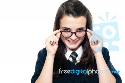 Schoolgirl Adjusting Her Spectacles Stock Photo