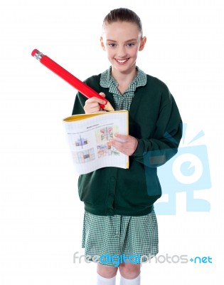 schoolGirl Drawing On Her Text Book Stock Photo