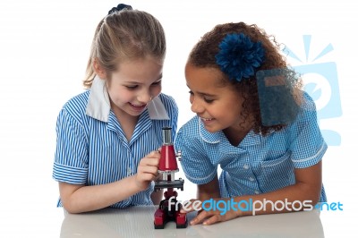 Schoolgirls Learning With Microscope Stock Photo