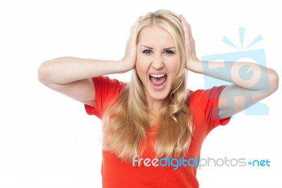 Screaming Young Woman Holding Her Head Stock Photo