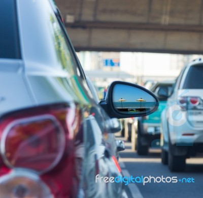 Sea View In Side Mirror Of Car With Traffic Jam Stock Photo