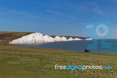 Seaford, Sussex/uk - April 5 : Man Sitting On A Bench Overlookin… Stock Photo