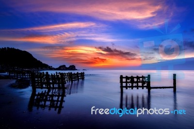 Seascape With Row Of Wood At Sunset Stock Photo