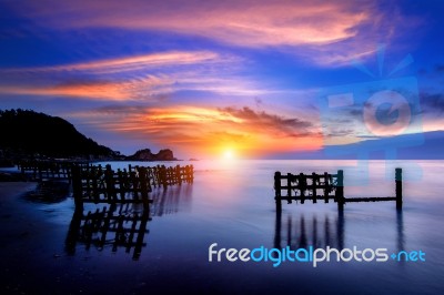 Seascape With Row Of Wood At Sunset Stock Photo