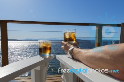 Seaside Deck Cocktails Man Arm Stock Photo