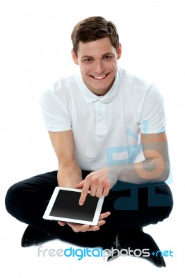 Seated Guy Using Touch Pad Device Stock Photo