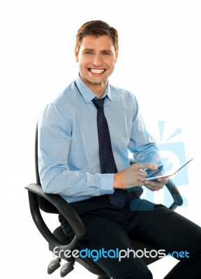 Seated Young Male Using Tablet Pc Stock Photo