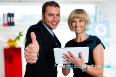 Secretary With A Tablet Posing With Her Successful Boss Stock Photo