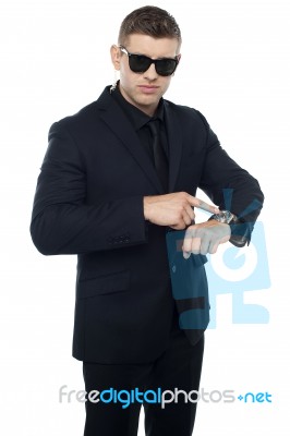 Security Officer Pointing At Watch Stock Photo