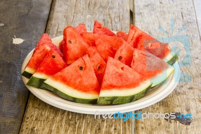 Seedless Watermelon Cut Into Wedges Serving On Dish Stock Photo