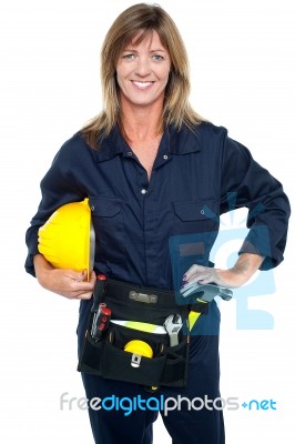 Self Assured Female Architect Holding Hard Hat Stock Photo