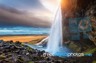 Seljalandsfoss Waterfall During The Sunset, Beautiful Waterfall In Iceland Stock Photo