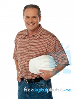 Senior Architect Holding Safety Hat Stock Photo