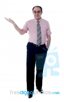 Senior Boss Posing With Open Palm Stock Photo