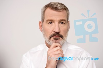 Senior Businessman Thinking Deeply Stock Photo