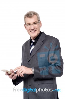 Senior Businessman Using A Cell Phone Stock Photo